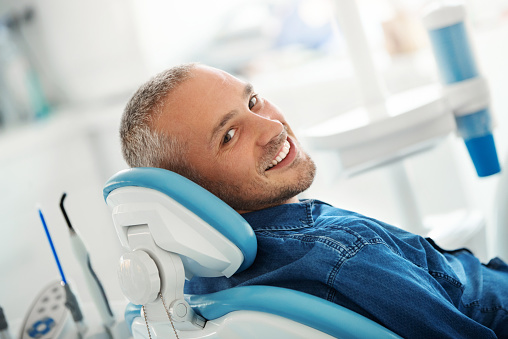A smiling male Jupiter patient in a dental office chair at Roy C. Blake III, DDS, MSD, Maxillofacial Prosthodontist in Jupiter Florida.